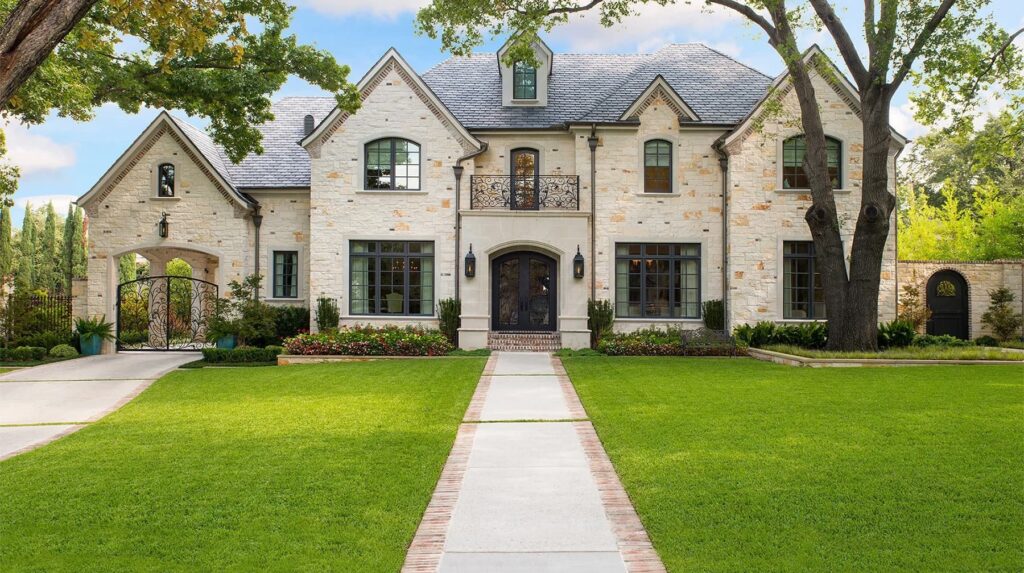 Grand luxury custom home exterior with stone façade and formal front approach in Dallas, TX