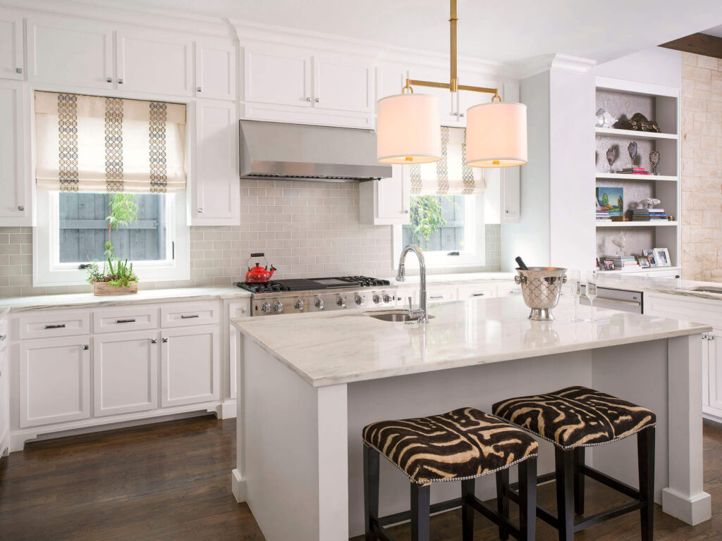 Luxury custom home kitchen with white cabinetry, island, and pendant lights in Dallas, TX
