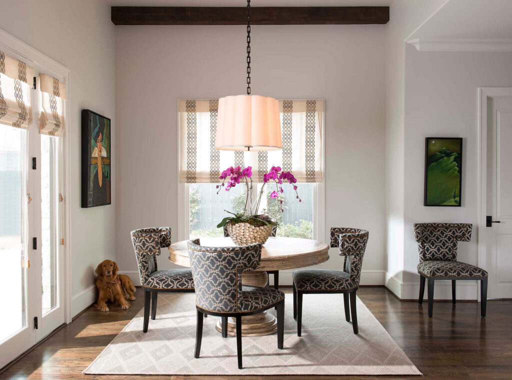 Round breakfast nook with upholstered chairs and pendant light in Dallas custom home