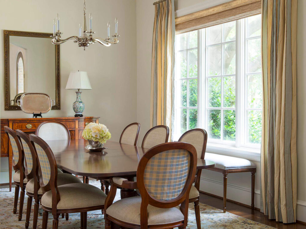 Dining room with large window and traditional chandelier in Dallas custom home