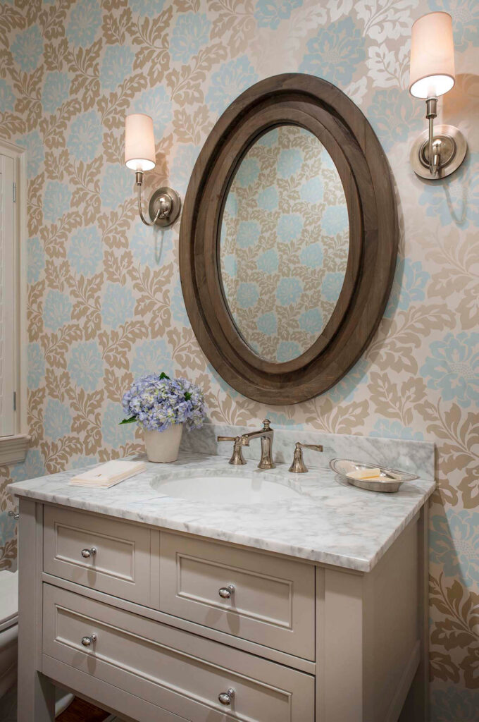 Bathroom vanity with marble countertop and oval mirror in Dallas, TX