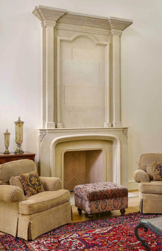 Living room with carved stone fireplace and upholstered seating in Dallas custom home