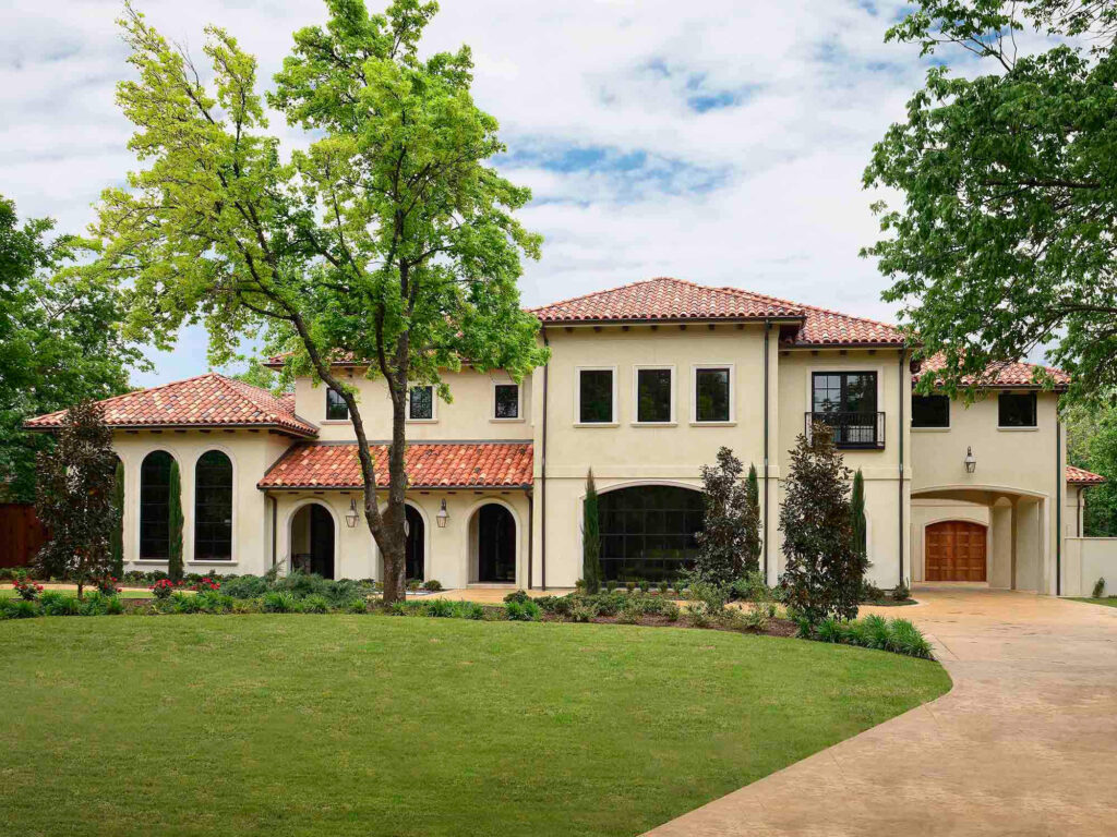Mediterranean-style custom home exterior with stucco walls and tile roof in Dallas, TX