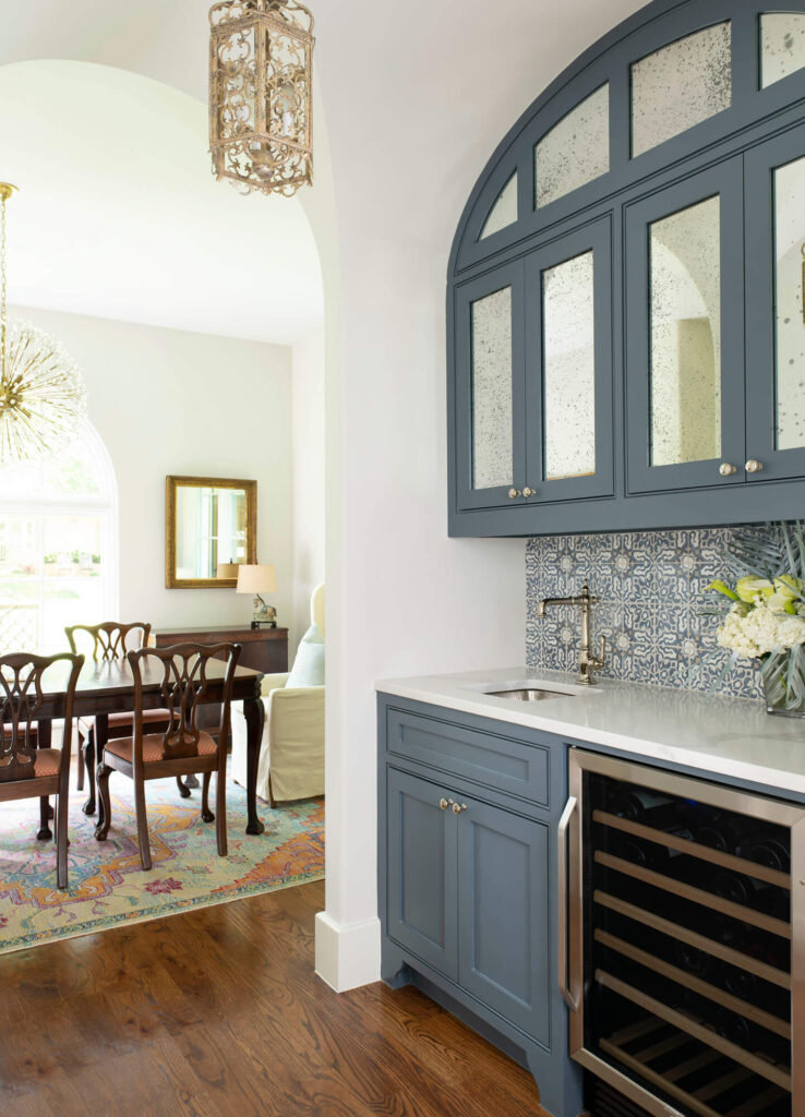 Built-in bar area with blue cabinetry and tile backsplash in Dallas custom home