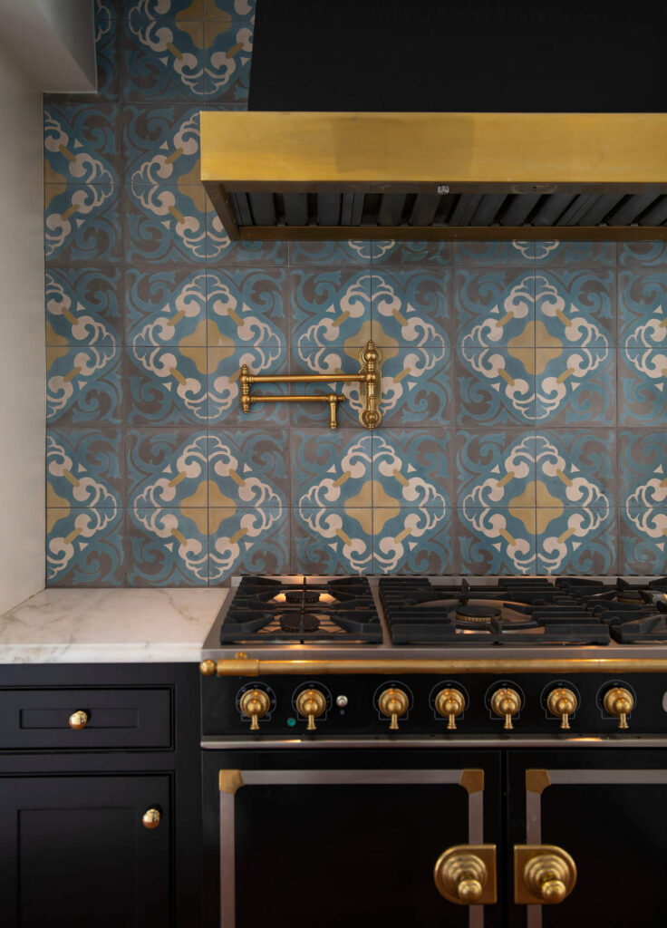 Patterned tile kitchen backsplash above range in luxury custom home in Dallas, TX