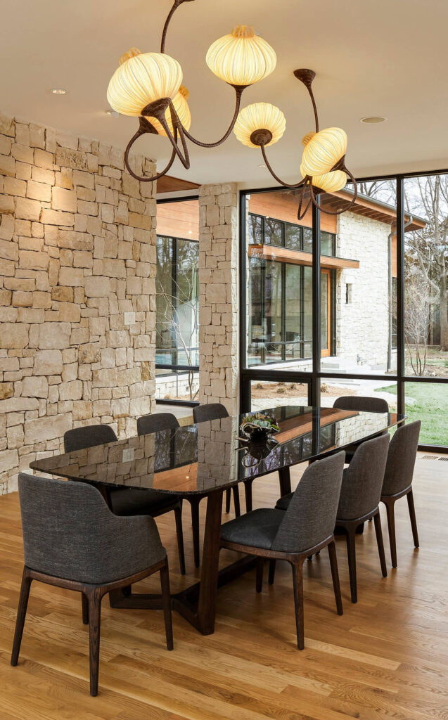 Dining area with stone accent wall and large windows in Dallas, TX
