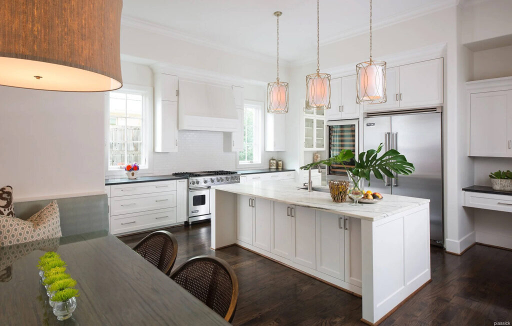 White kitchen with large island and pendant lighting in Dallas luxury home