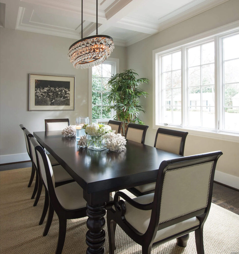 Formal dining room with dark wood table and crystal chandelier in Dallas, TX