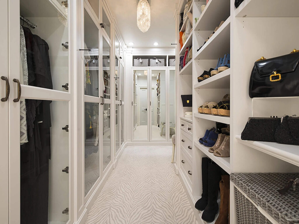 Custom walk-in closet with built-in shelving in Dallas luxury home