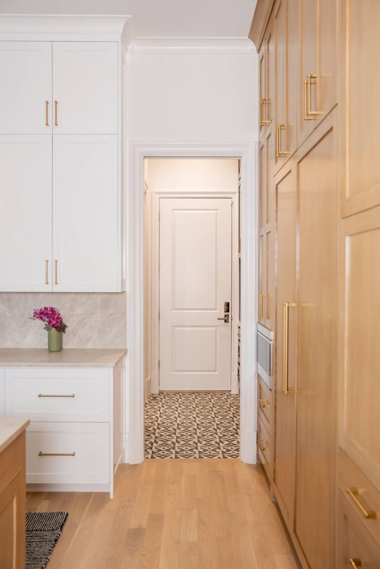Brunswick pantry hallway with custom cabinetry and patterned tile floor in Dallas