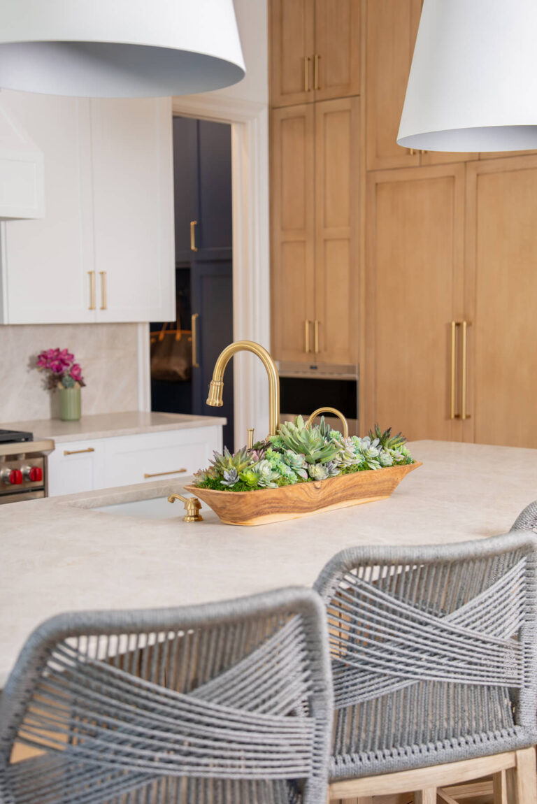 Brunswick quartz kitchen island with brass faucet and custom cabinetry in Midway Hollow