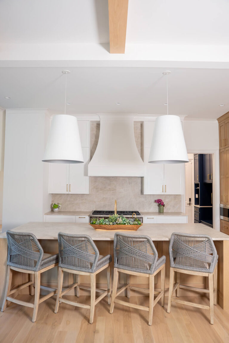 Brunswick transitional kitchen with oversized white hood and woven bar stools in Dallas