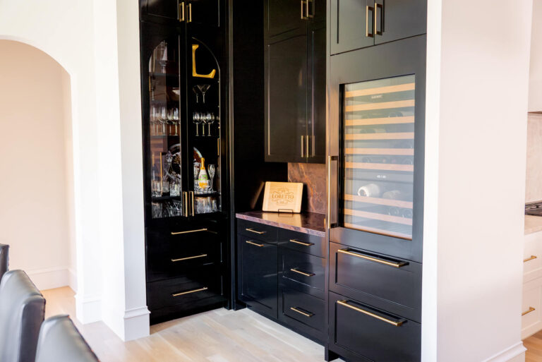 Brunswick black built-in wet bar with glass-front wine cooler in Dallas custom home