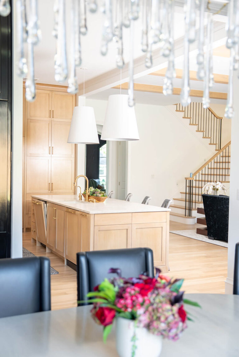 Brunswick custom kitchen with light wood cabinetry and open staircase in Midway Hollow Dallas