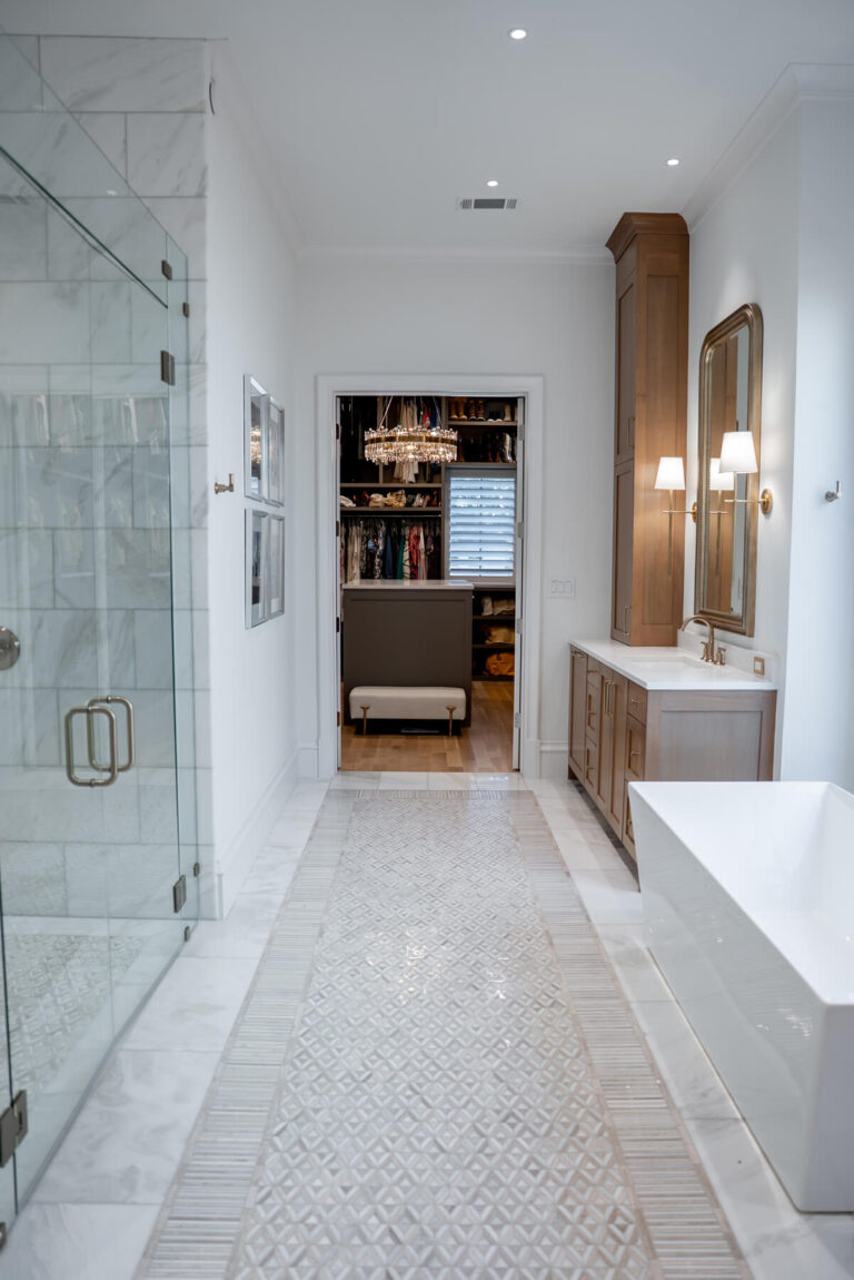 Brunswick primary bathroom with glass shower and herringbone tile floor in Dallas