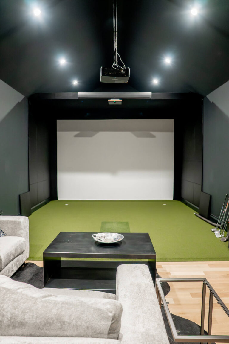 Brunswick golf simulator room with projection screen in Midway Hollow custom home
