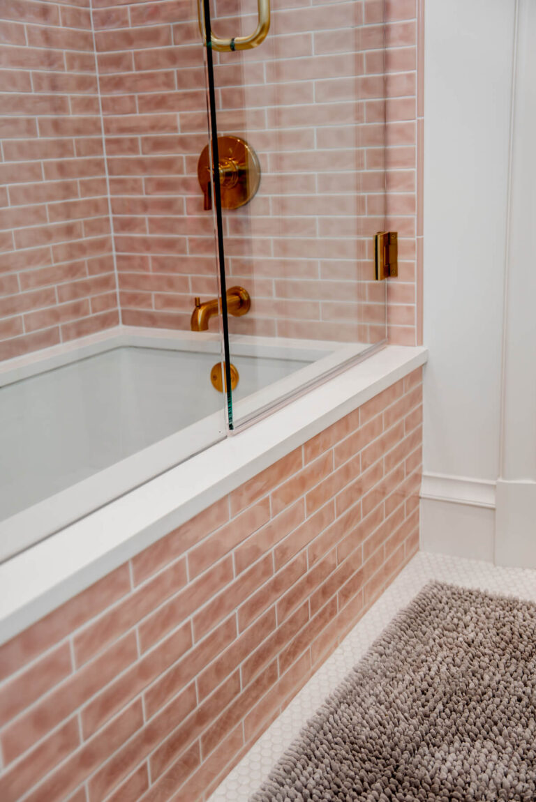 Brunswick bathroom with pink tile shower surround and brass fixtures in Dallas