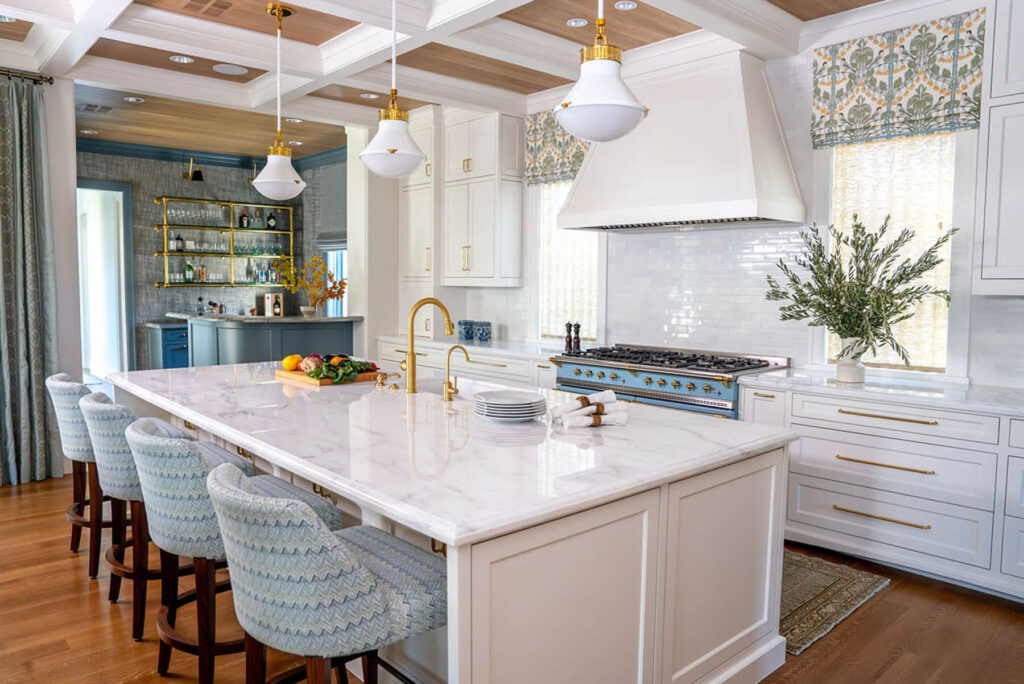 White marble kitchen island with brass faucet in Bryn Mawr custom home