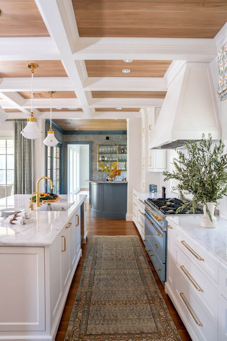 White and brass chef's kitchen with coffered ceiling in Bryn Mawr home