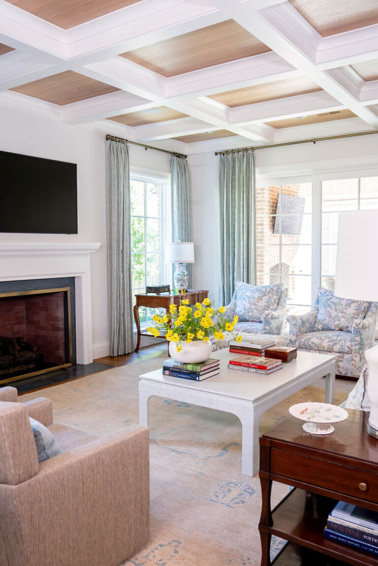 Traditional living room with marble fireplace and yellow floral arrangement