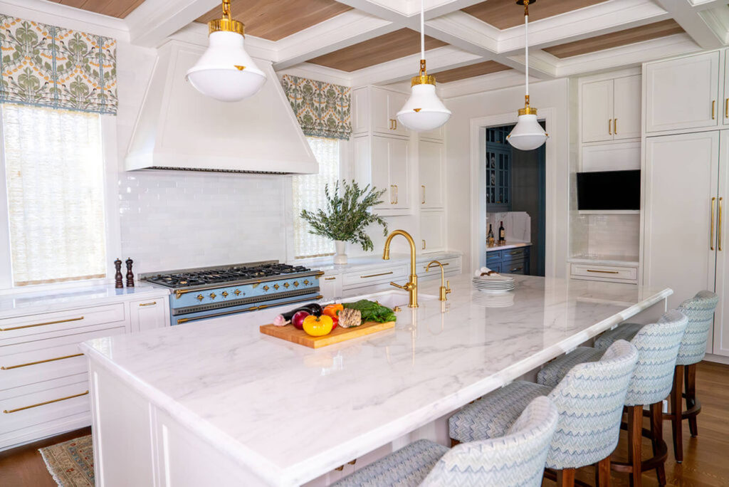 Marble kitchen island with brass hardware and custom hood