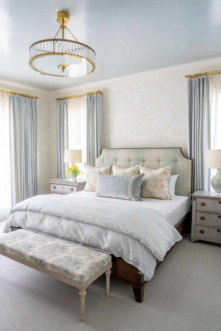 Soft neutral bedroom with custom upholstery and layered bedding