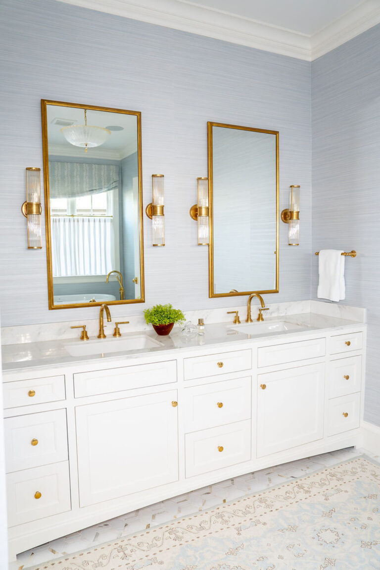 White double vanity with brass mirrors and sconces in Bryn Mawr bathroom