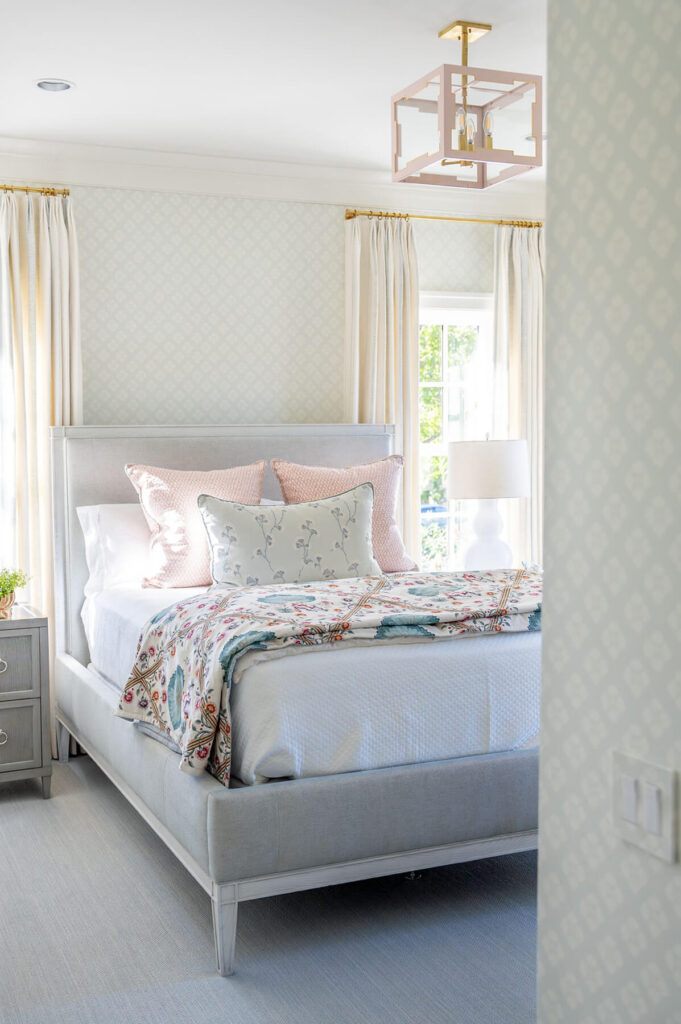 Classic bedroom with patterned wallpaper and custom bedding