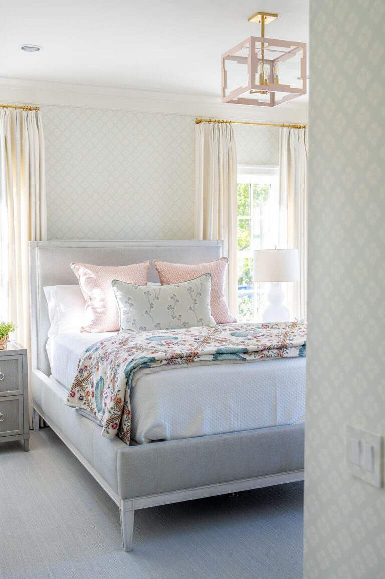 Classic bedroom with patterned wallpaper and custom bedding