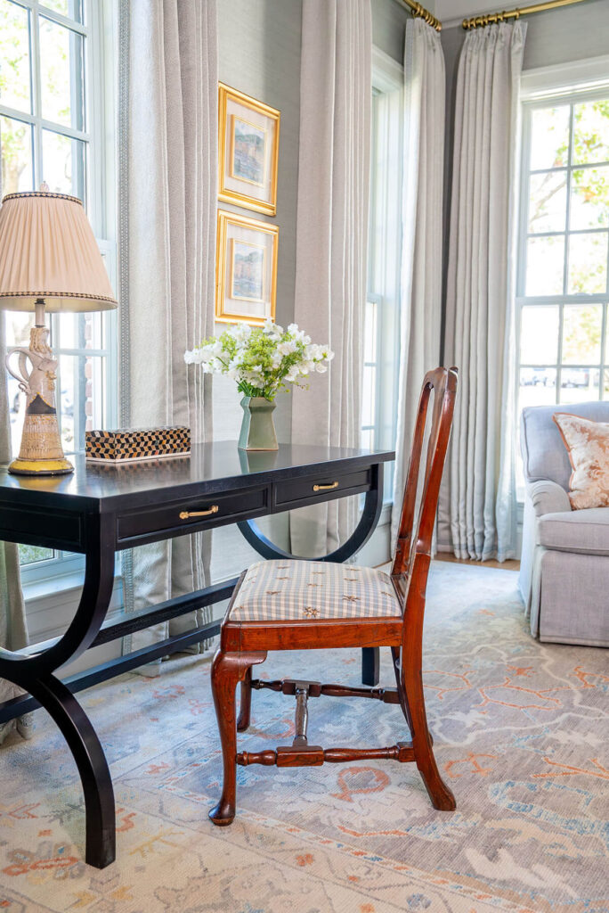 Light-filled sitting room with antique desk and soft blue accents in Bryn Mawr project