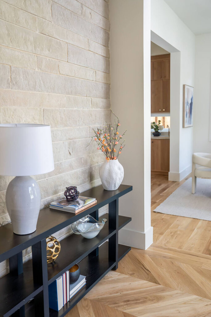 Lyre Lane interior stone feature wall with modern console table in Dallas custom home