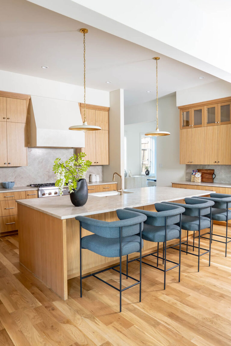 Lyre Lane kitchen with waterfall island and teal bar stools in Dallas custom home