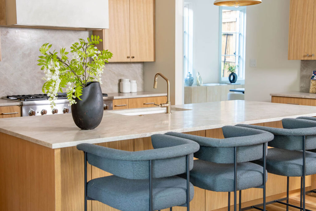 Lyre Lane kitchen island with quartz countertops and wood cabinetry in Dallas home