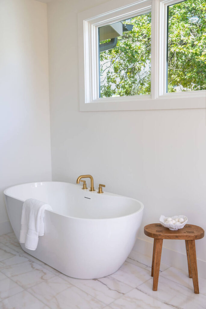 Lyre Lane freestanding soaking tub with gold fixtures in Dallas custom bathroom