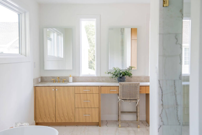 Lyre Lane primary bathroom vanity with natural wood cabinetry in Dallas home