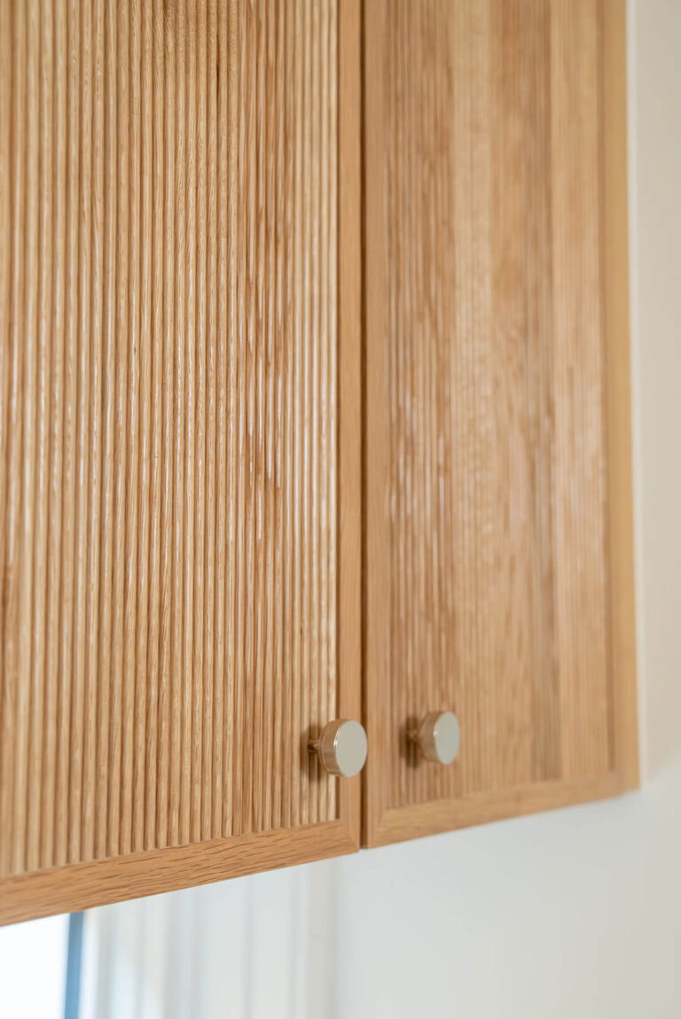 Lyre Lane fluted light wood cabinetry detail in Dallas custom home